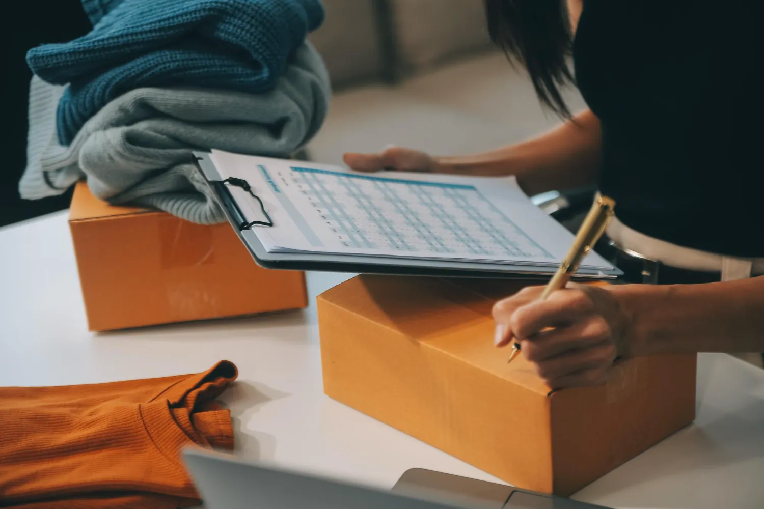 A store owner checking a schedule on a clipboard between parcels