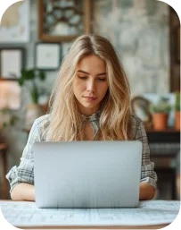 A woman working on a laptop in her living room