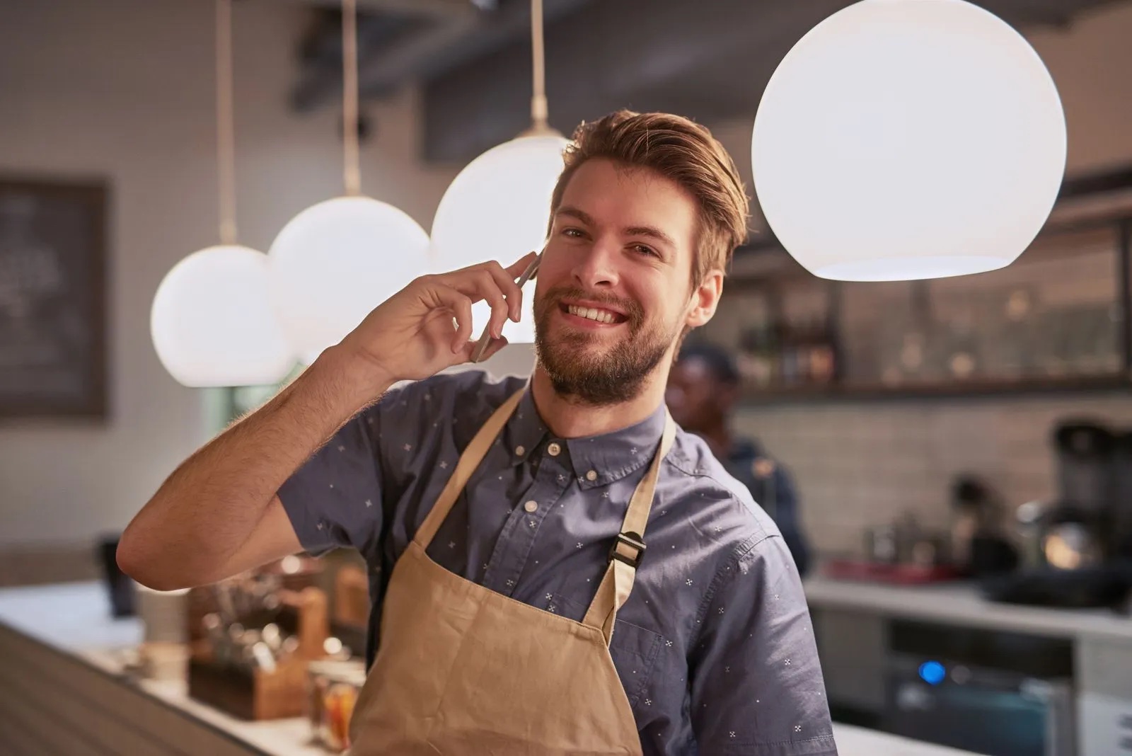 A retail employee holding a phone