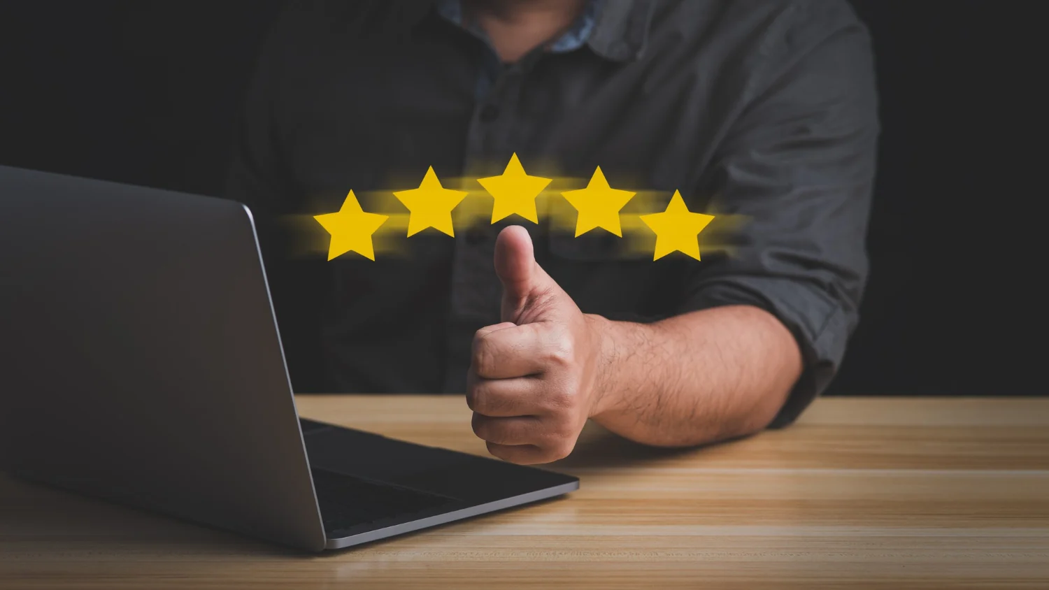 A thumbs-up beside a laptop under a five-star rating