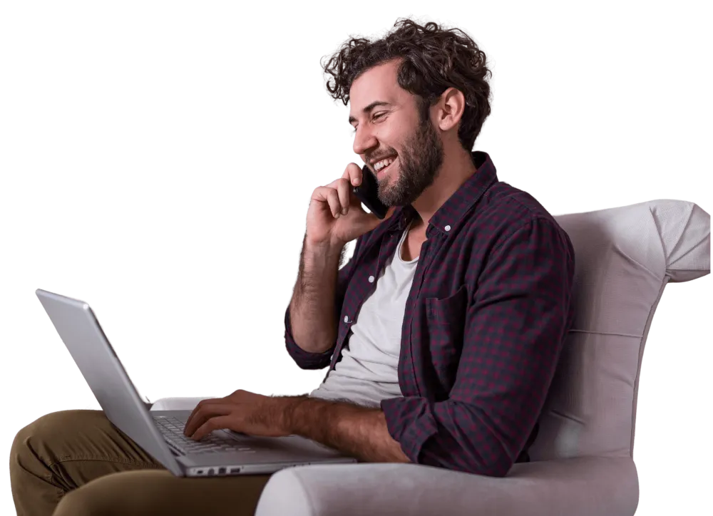 A man on a call with his laptop, relaxed on a couch